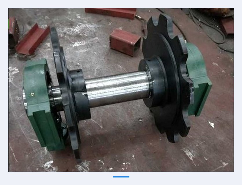 Roller table and sprocket components of a cold bed conveyor